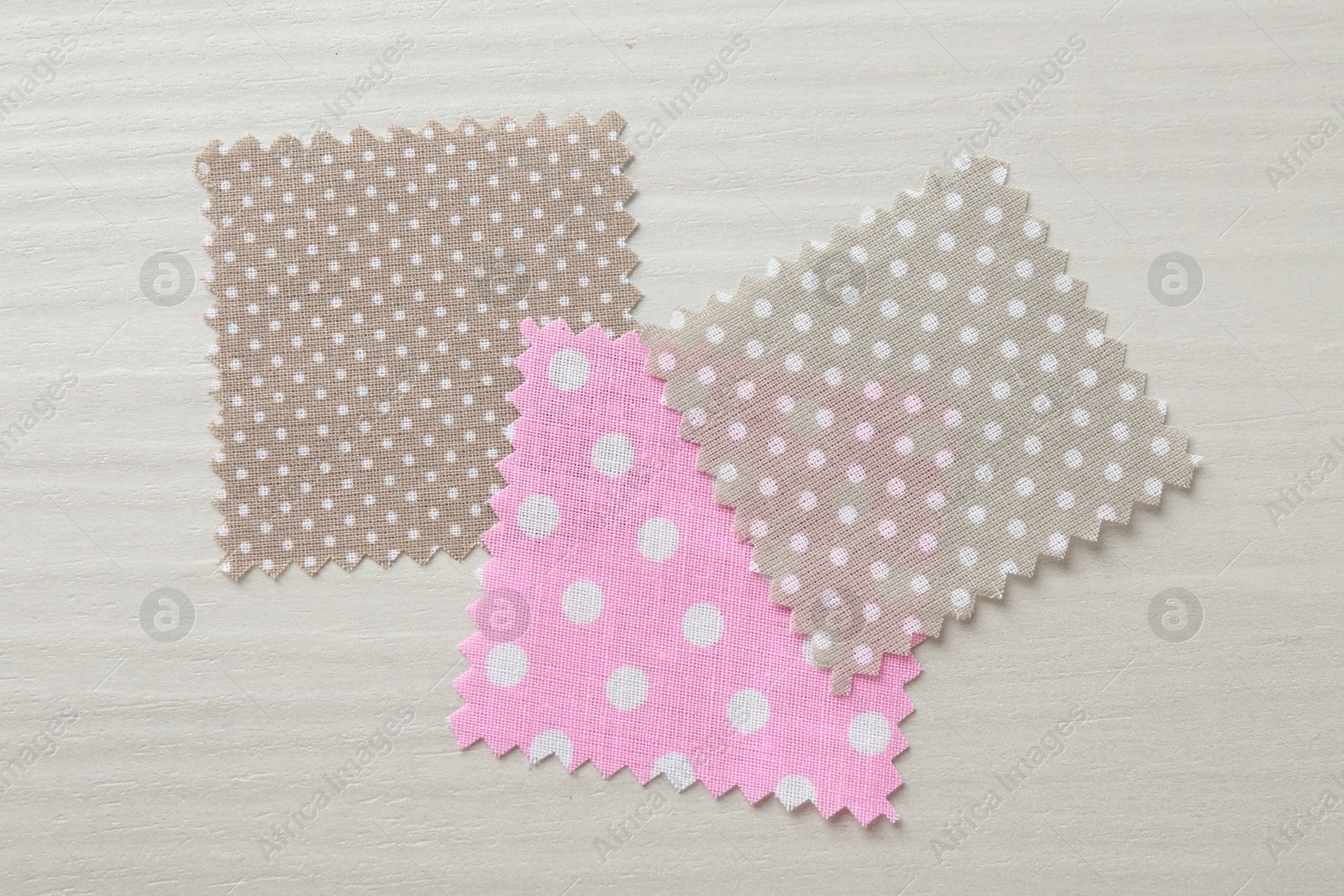 Samples of different fabrics on white wooden table, flat lay Photo of Samples of different fabrics on white wooden table, flat lay
