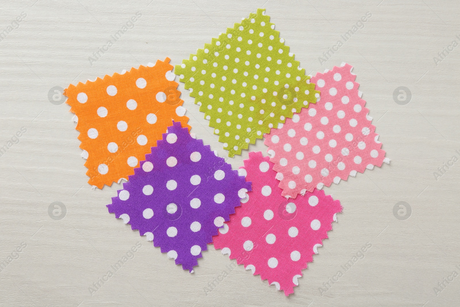 Samples of different fabrics on white wooden table, flat lay Photo of Samples of different fabrics on white wooden table, flat lay