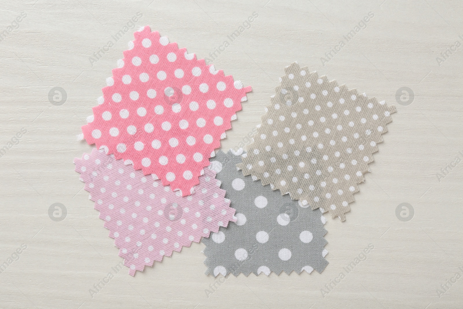 Samples of different fabrics on white wooden table, flat lay Photo of Samples of different fabrics on white wooden table, flat lay