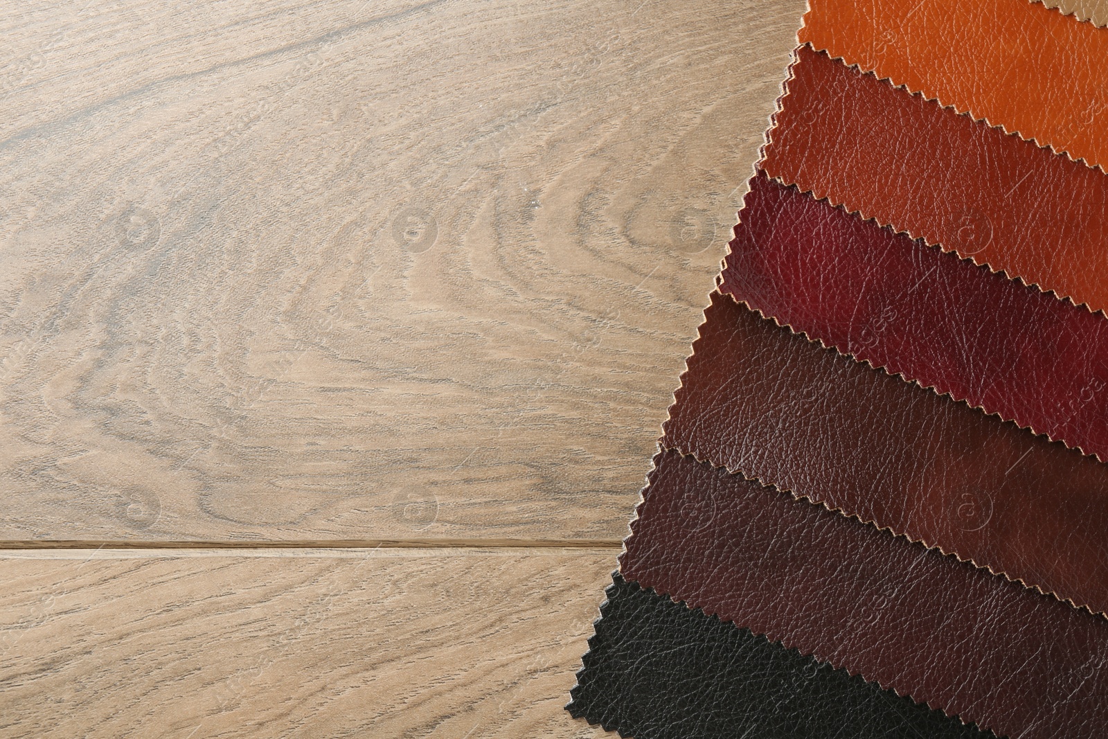 Samples of different fabrics on wooden table, top view. Space for text Photo of Samples of different fabrics on wooden table, top view. Space for text