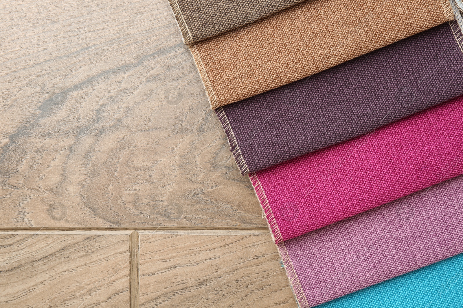 Samples of different fabrics on wooden table, top view. Space for text Photo of Samples of different fabrics on wooden table, top view. Space for text
