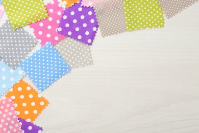 Photo of Samples of different fabrics on white wooden table, flat lay. Space for text