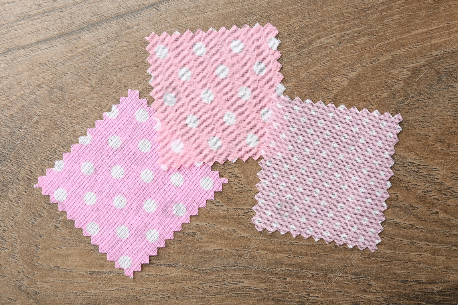 Samples of different fabrics on wooden table, flat lay Photo of Samples of different fabrics on wooden table, flat lay