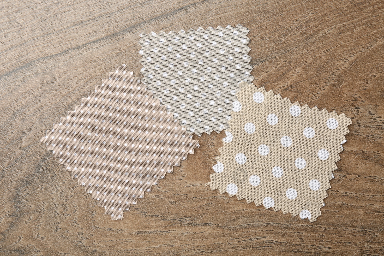 Samples of different fabrics on wooden table, flat lay Photo of Samples of different fabrics on wooden table, flat lay