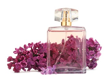 Photo of Bottle of luxury perfume and lilac flowers isolated on white