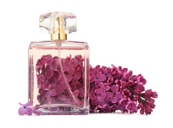 Photo of Bottle of luxury perfume and lilac flowers isolated on white