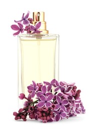 Photo of Bottle of luxury perfume and lilac flowers isolated on white