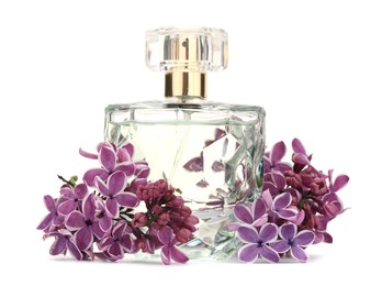 Photo of Bottle of luxury perfume and lilac flowers isolated on white