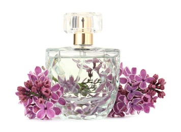Photo of Bottle of luxury perfume and lilac flowers isolated on white