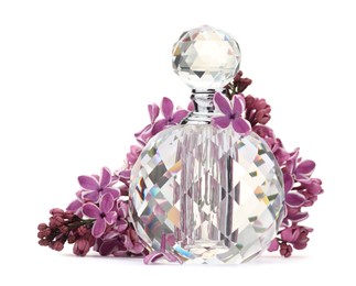 Photo of Bottle of luxury perfume and lilac flowers isolated on white