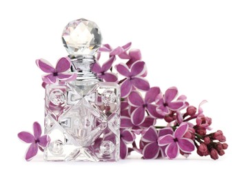 Photo of Bottle of luxury perfume and lilac flowers isolated on white