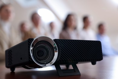 Photo of Modern video projector on table during conference
