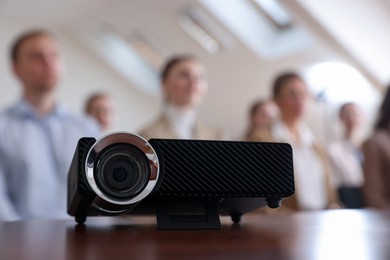 Photo of Modern video projector on table during conference