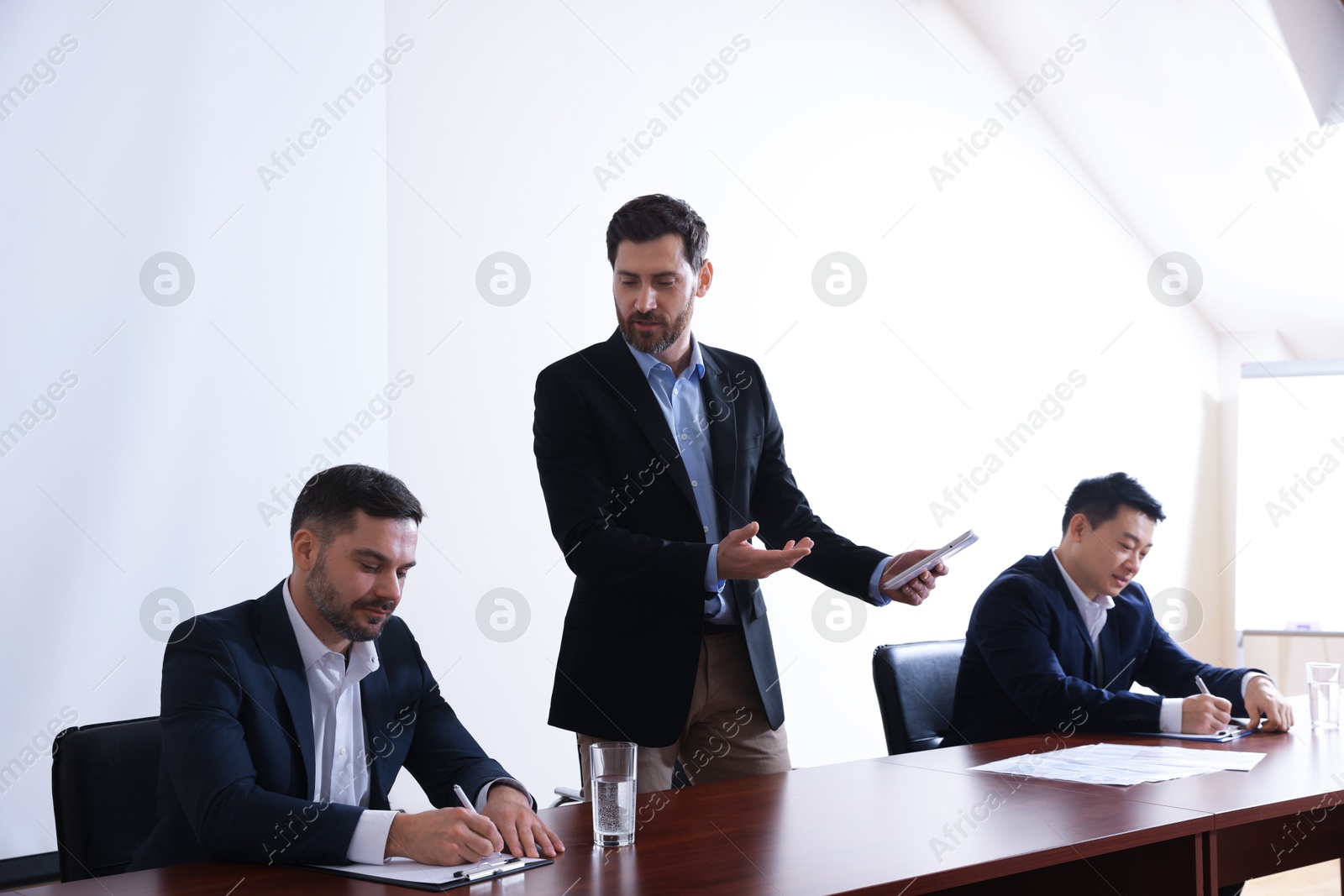 Business conference. People in meeting room listening to speaker report Photo of Business conference. People in meeting room listening to speaker report