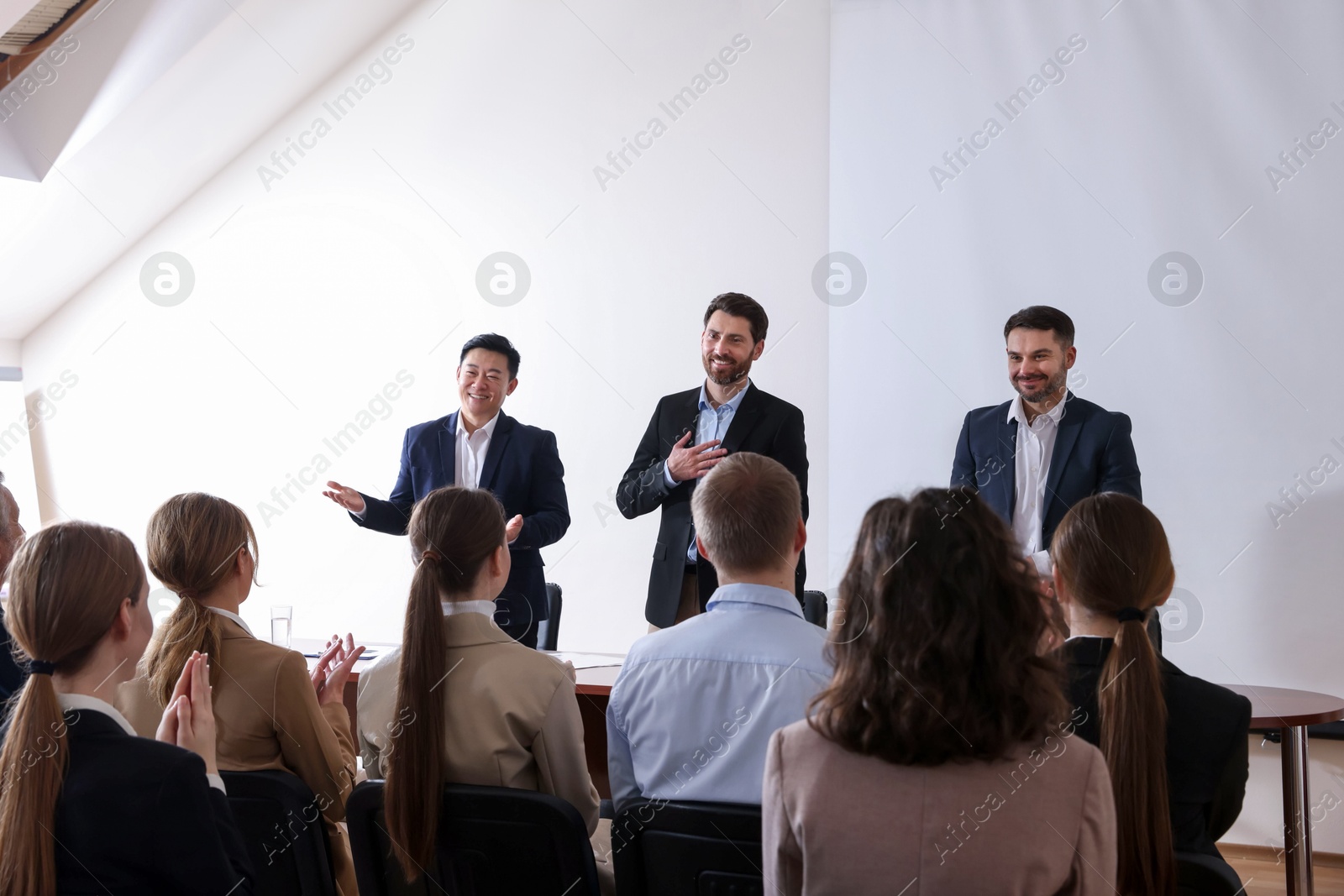 Business conference. People in meeting room listening to speaker report Photo of Business conference. People in meeting room listening to speaker report