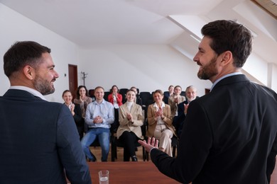 Photo of Business trainers giving lecture in conference room