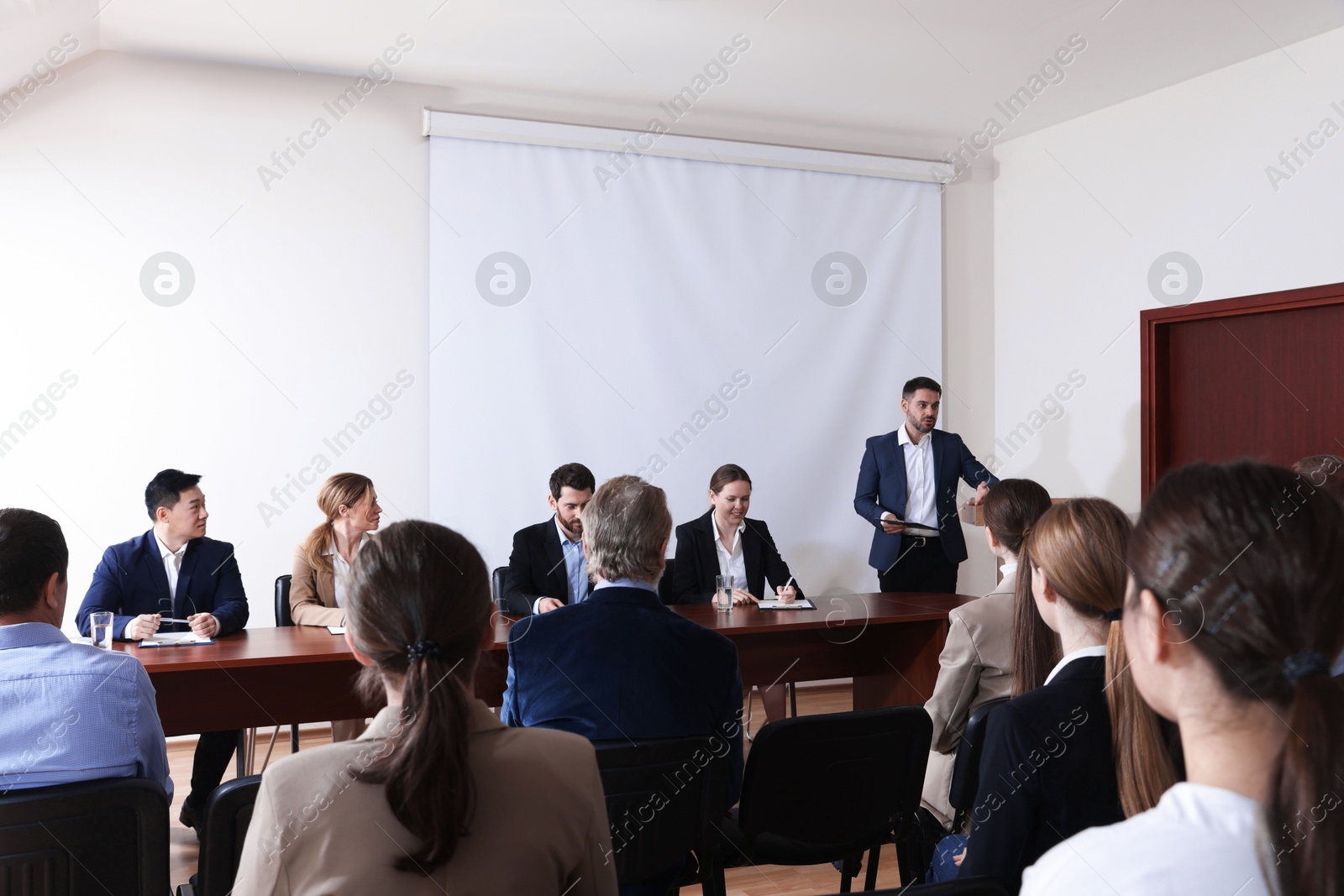 Business conference. People in meeting room listening to speaker report Photo of Business conference. People in meeting room listening to speaker report
