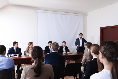 Photo of Business conference. People in meeting room listening to speaker report
