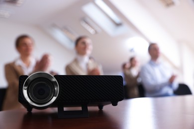 Photo of Modern video projector on table during conference
