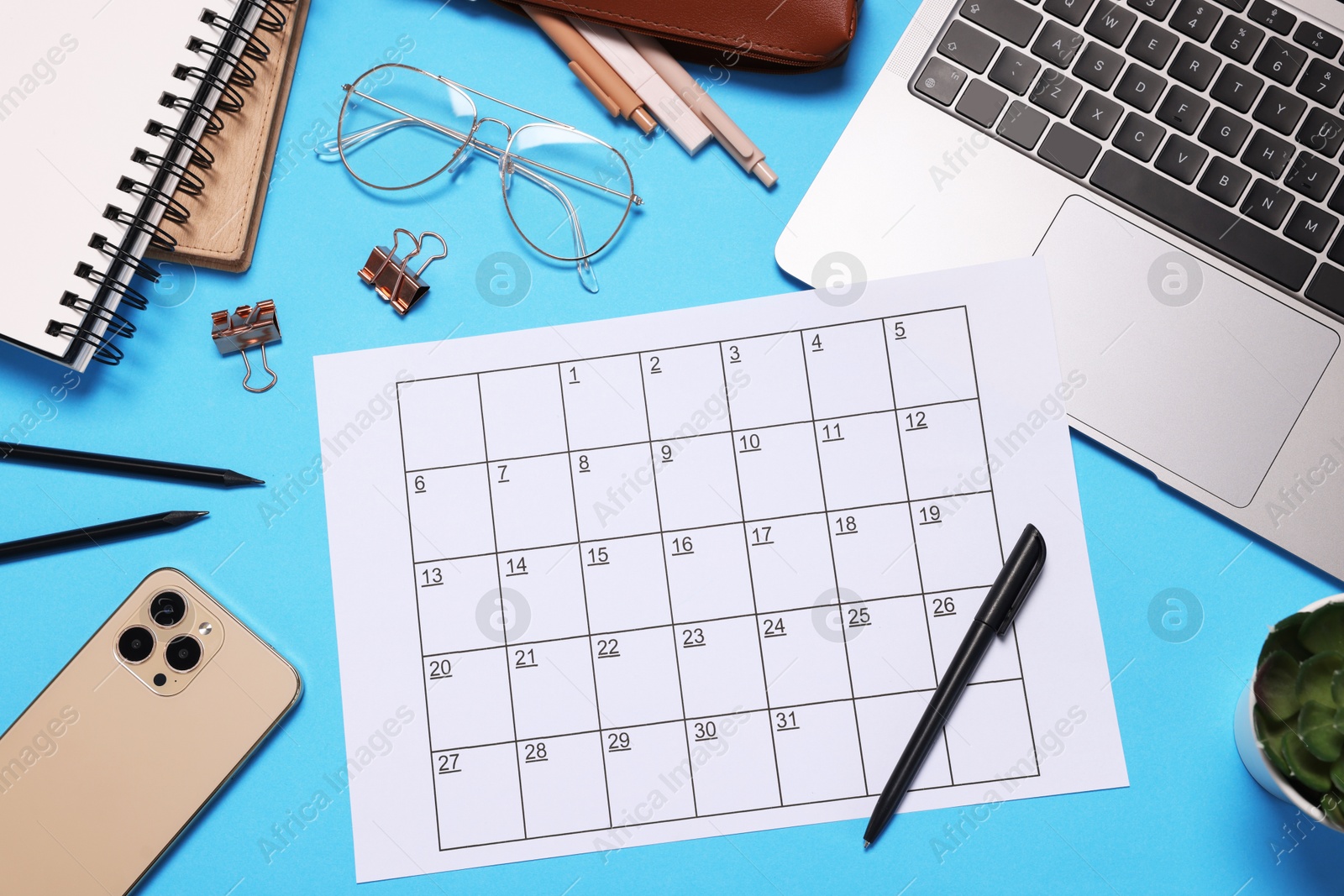 Planner, stationery, laptop and smartphone on light blue background, flat lay Photo of Planner, stationery, laptop and smartphone on light blue background, flat lay