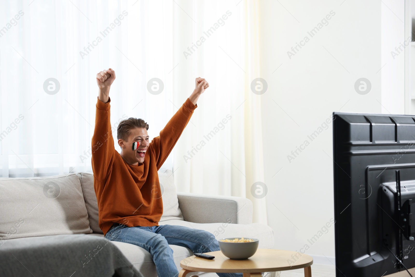 Emotional sports fan watching game at home Photo of Emotional sports fan watching game at home