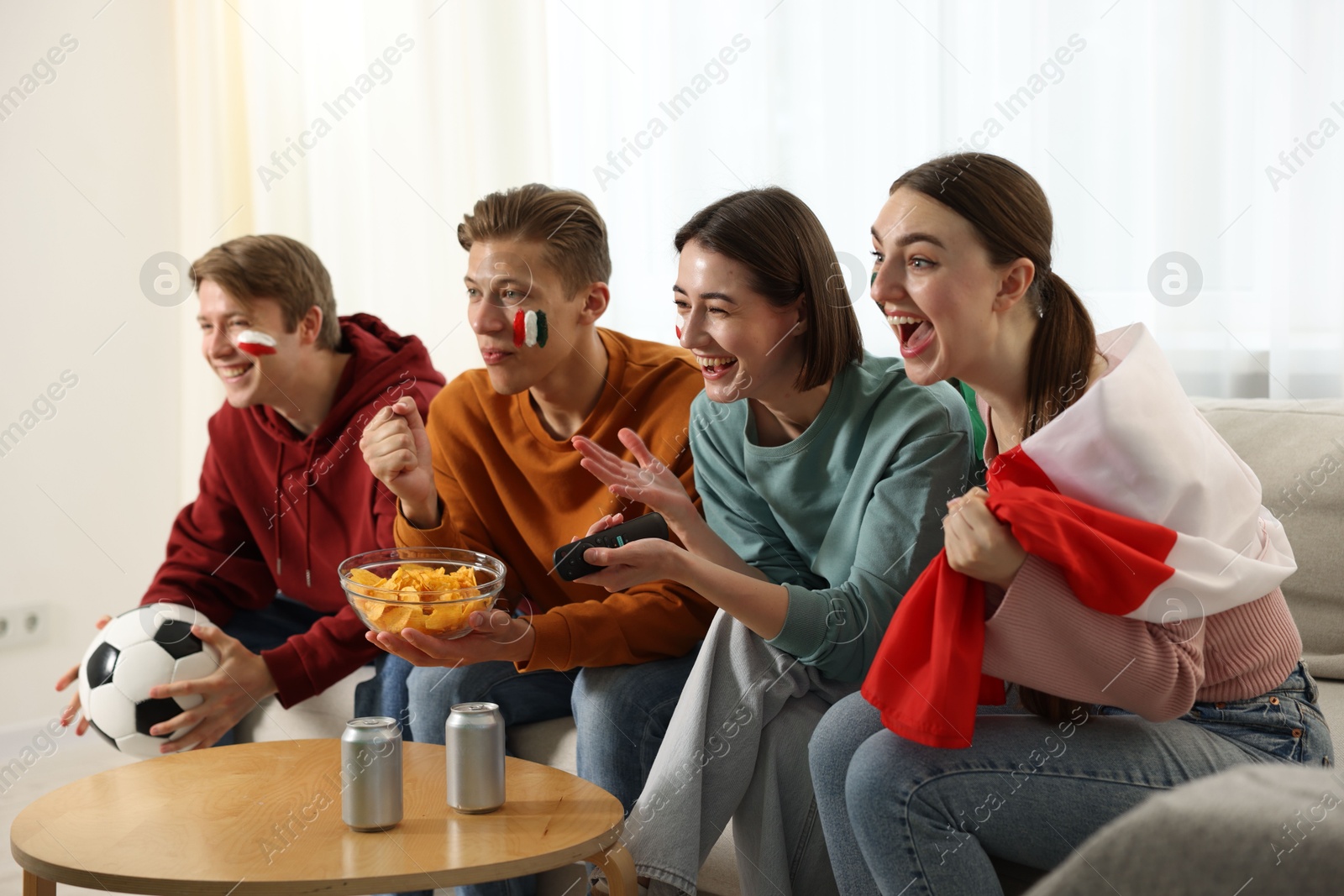 Emotional football fans watching game together indoors Photo of Emotional football fans watching game together indoors