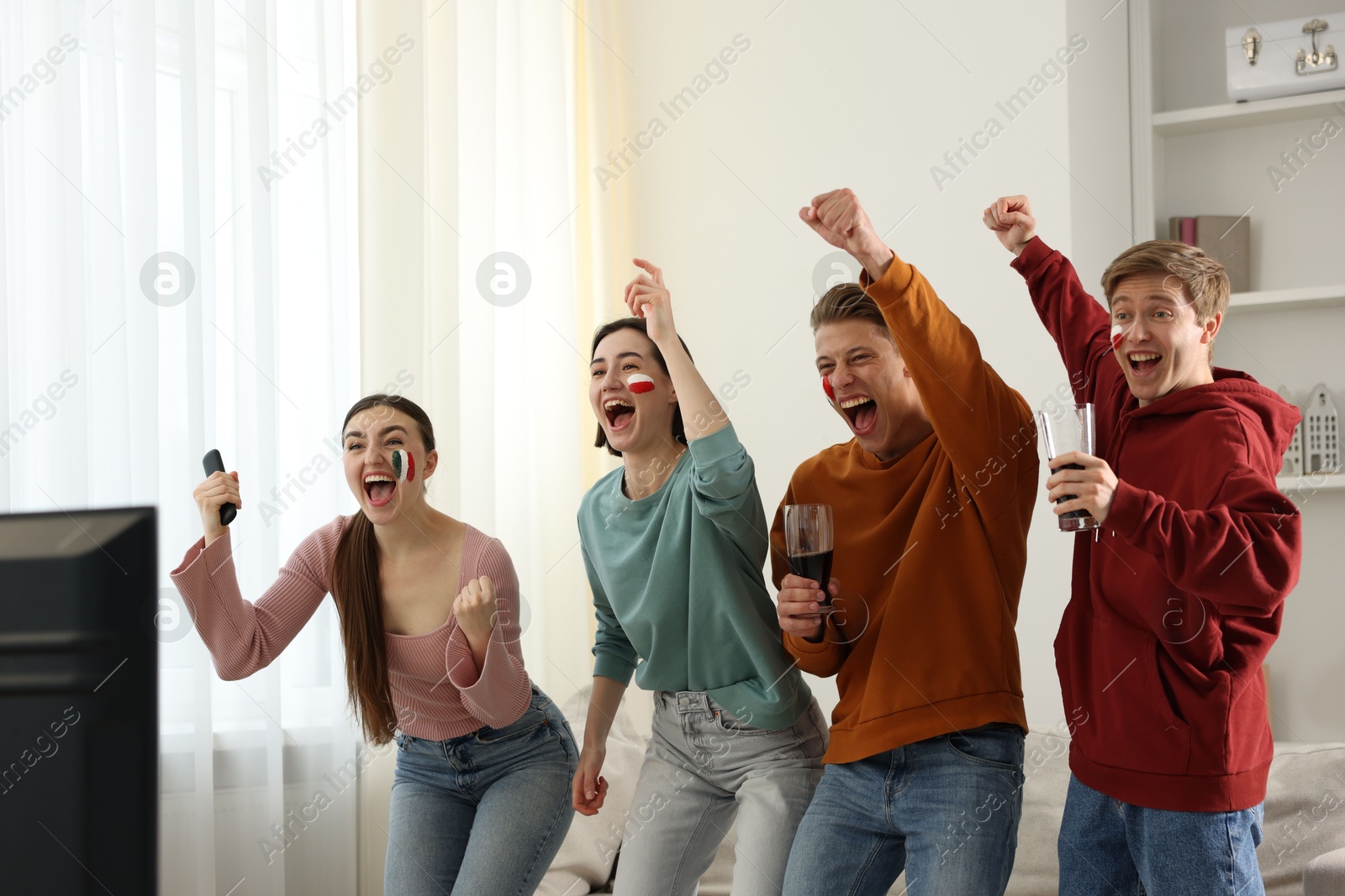 Emotional sports fans watching game together indoors Photo of Emotional sports fans watching game together indoors
