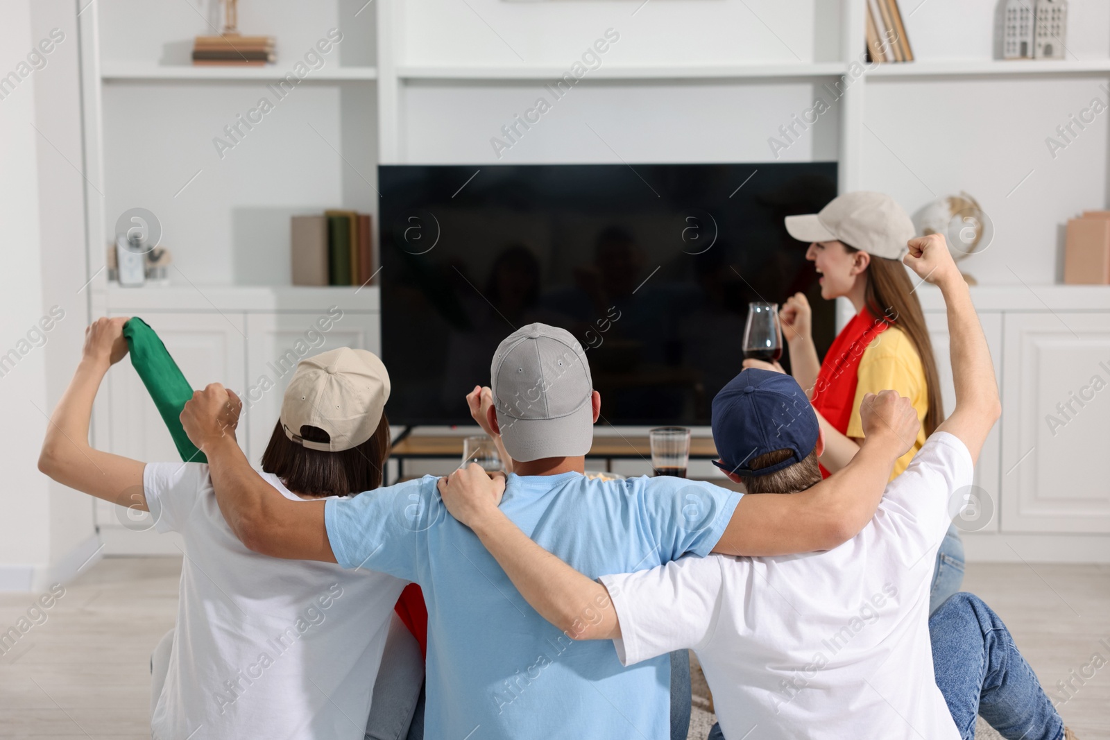 Emotional sports fans watching game together indoors Photo of Emotional sports fans watching game together indoors