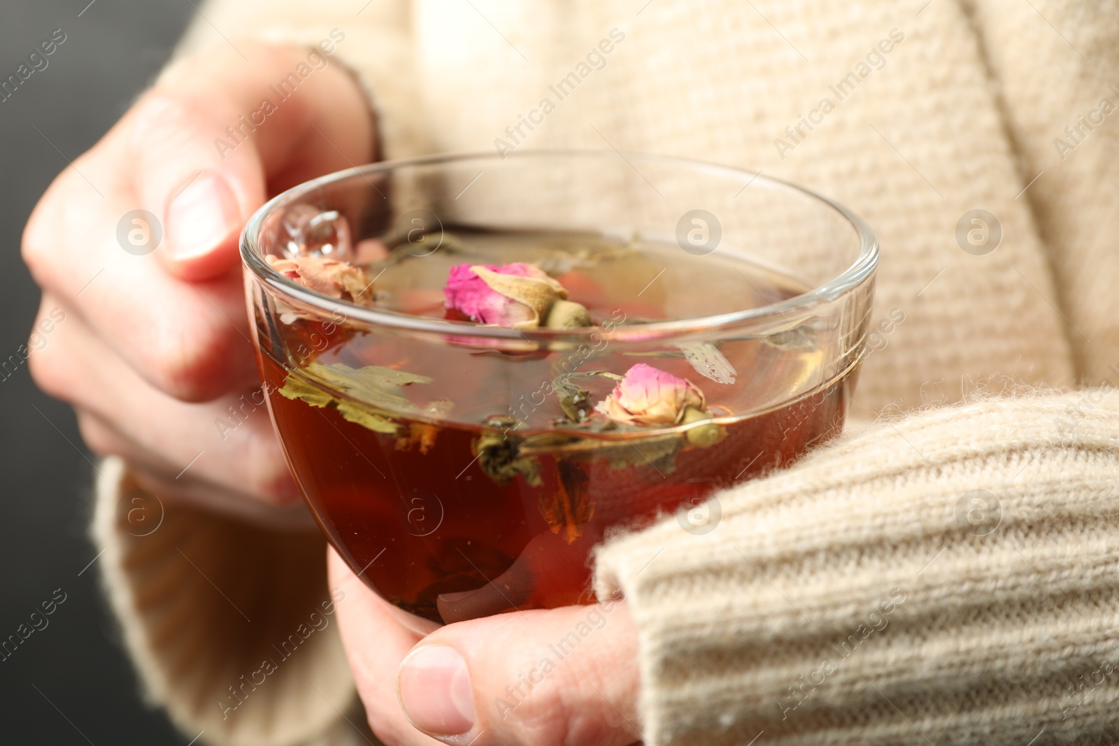 Woman with glass cup of aromatic herbal tea, closeup Photo of Woman with glass cup of aromatic herbal tea, closeup