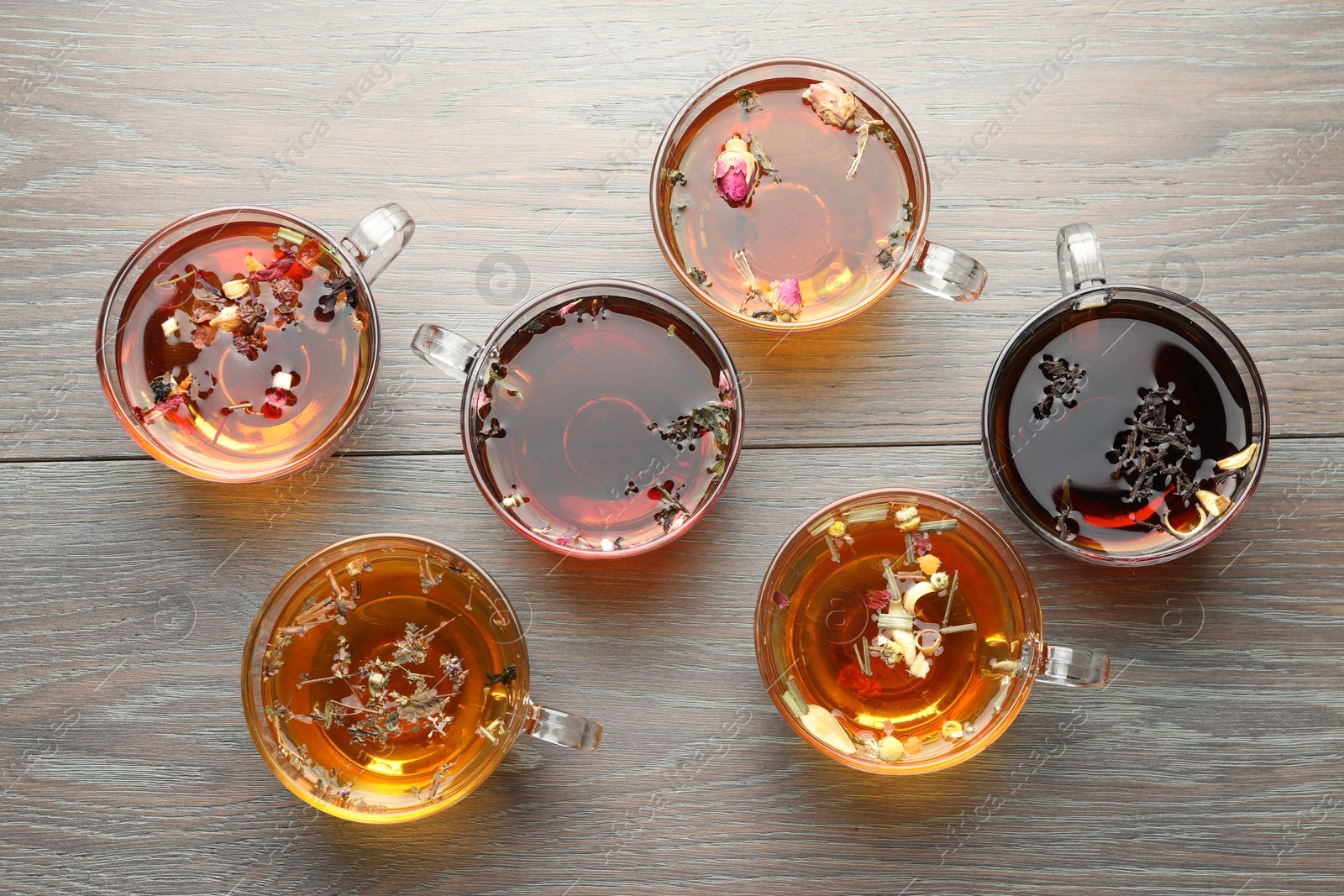 Aromatic herbal tea in glass cups on wooden table, flat lay Photo of Aromatic herbal tea in glass cups on wooden table, flat lay