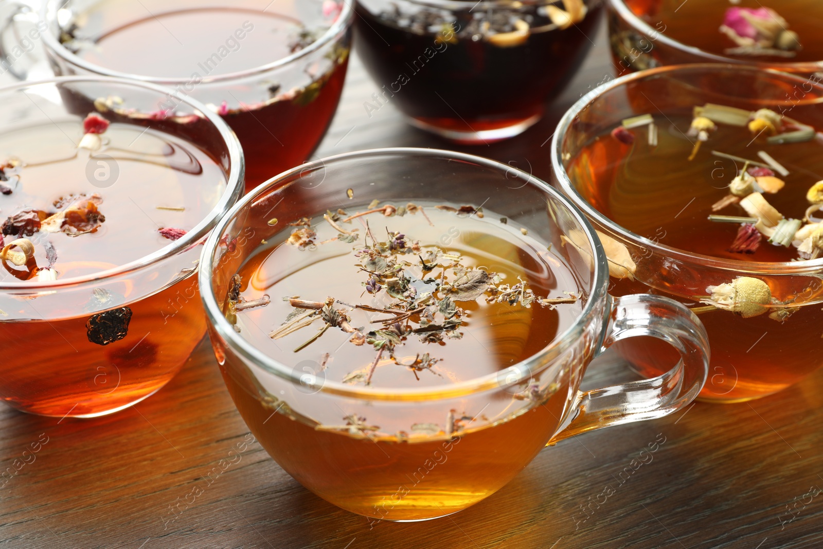 Aromatic herbal tea in glass cups on wooden table, closeup Photo of Aromatic herbal tea in glass cups on wooden table, closeup