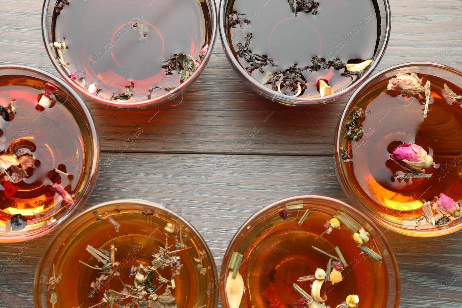 Aromatic herbal tea in glass cups on wooden table, flat lay. Space for text Photo of Aromatic herbal tea in glass cups on wooden table, flat lay. Space for text
