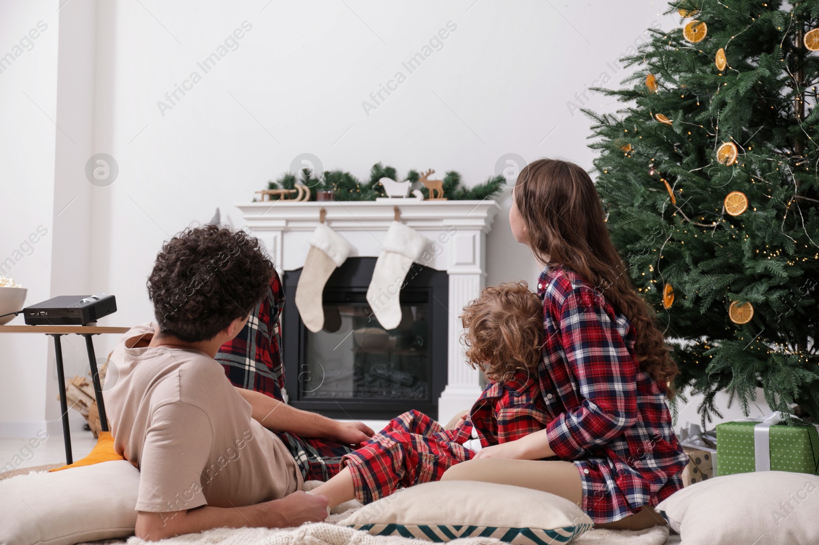 Family watching movie via video projector at home Photo of Family watching movie via video projector at home