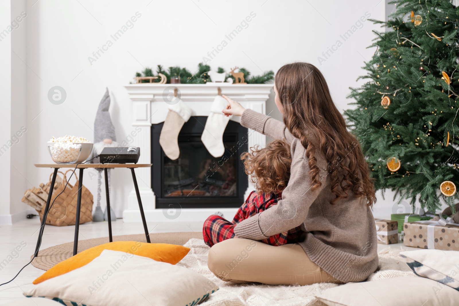 Mother and son watching movie via video projector at home Photo of Mother and son watching movie via video projector at home
