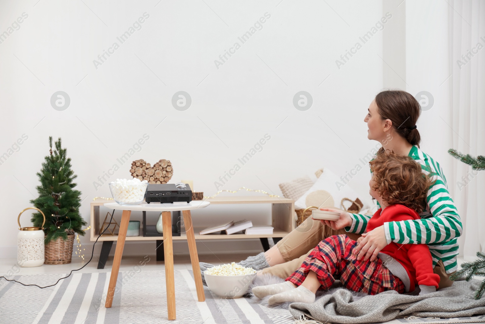 Family watching movie via video projector at home Photo of Family watching movie via video projector at home