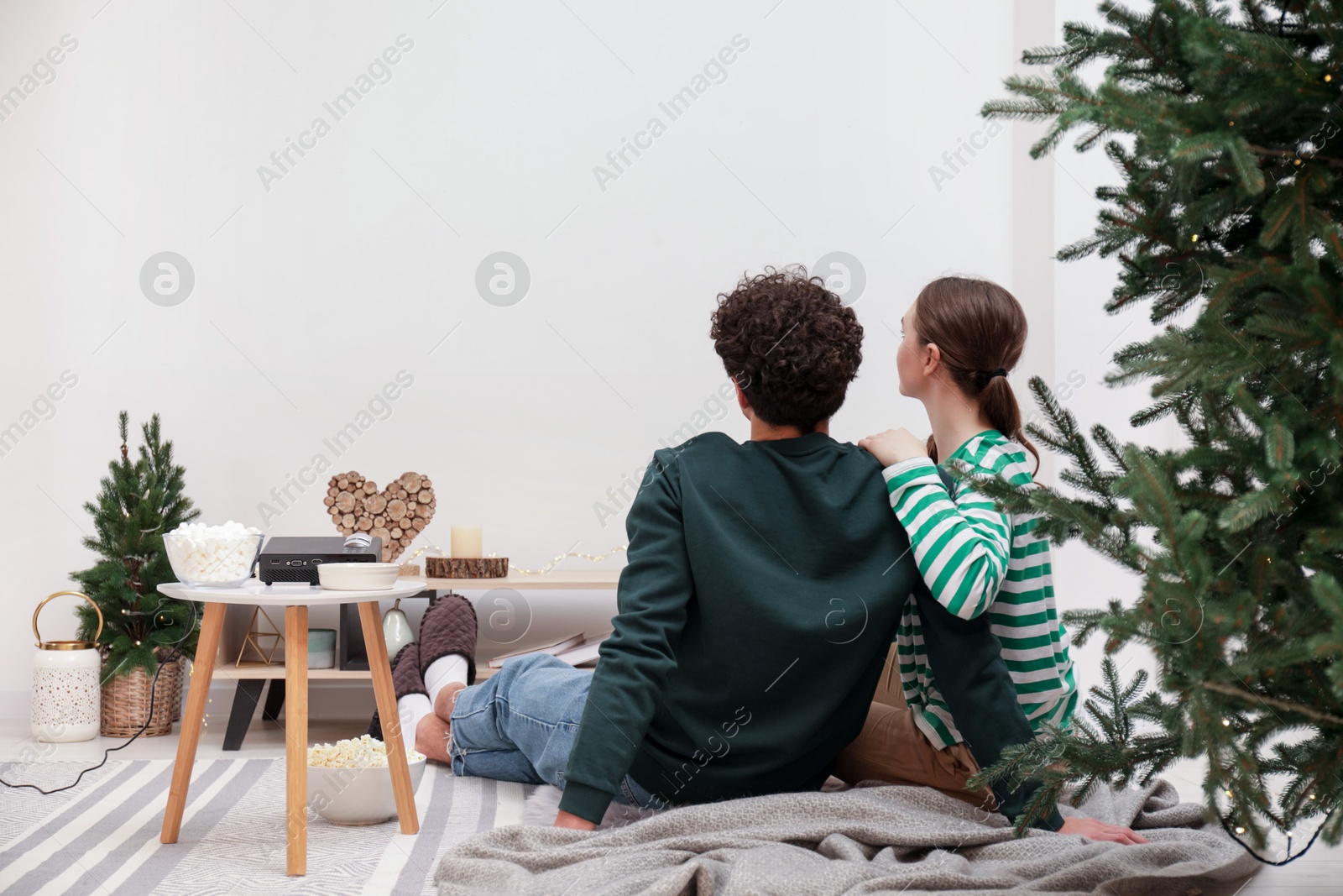 Couple watching movie via video projector at home Photo of Couple watching movie via video projector at home