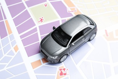 Photo of Road trip concept. Car model on city map