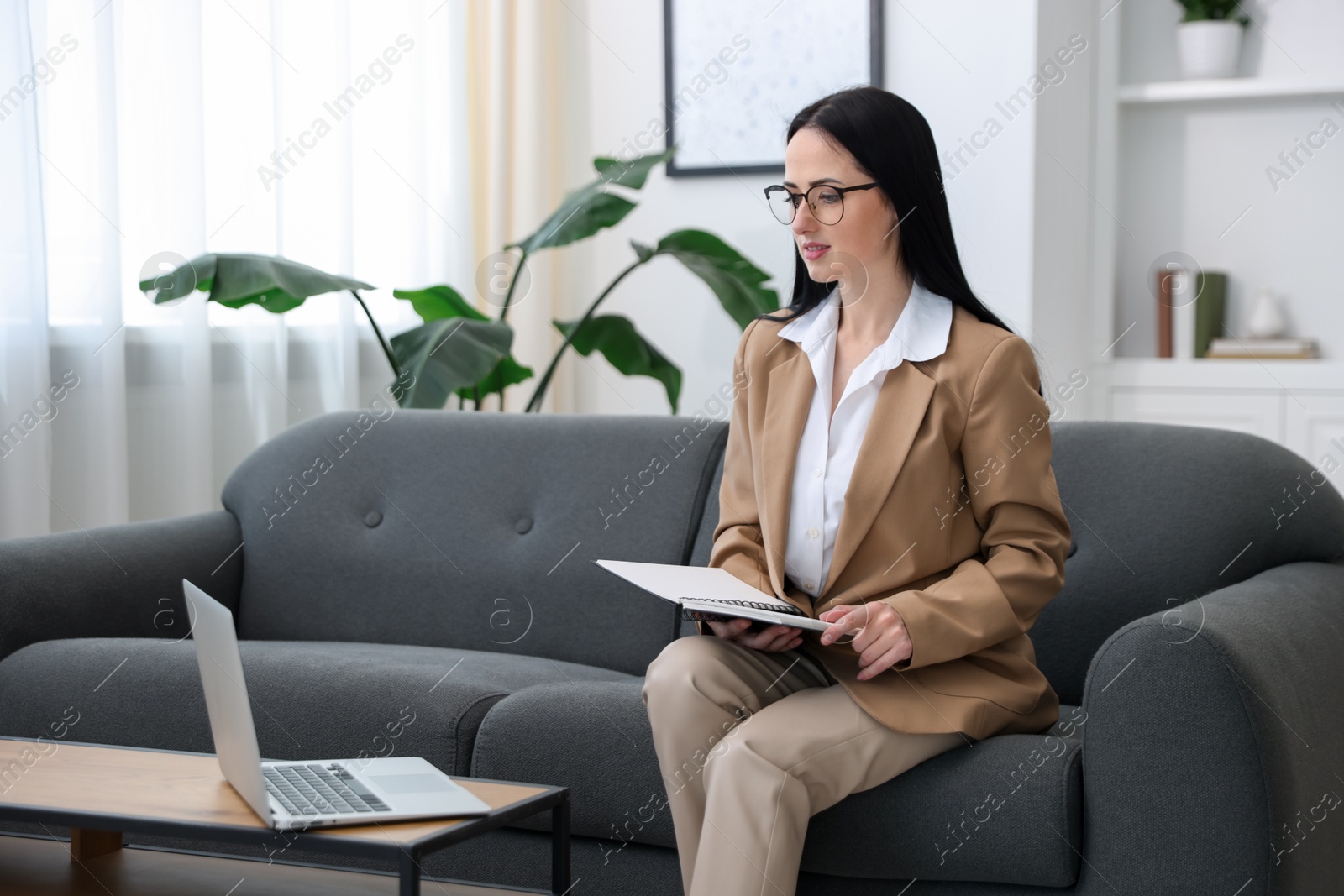 Professional psychologist working with laptop in office Photo of Professional psychologist working with laptop in office