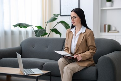 Photo of Professional psychologist working with laptop in office