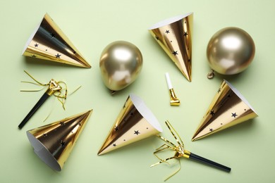 Photo of Flat lay composition with party hats on light green background