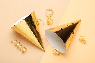 Photo of Party hats and streamers on color background, flat lay