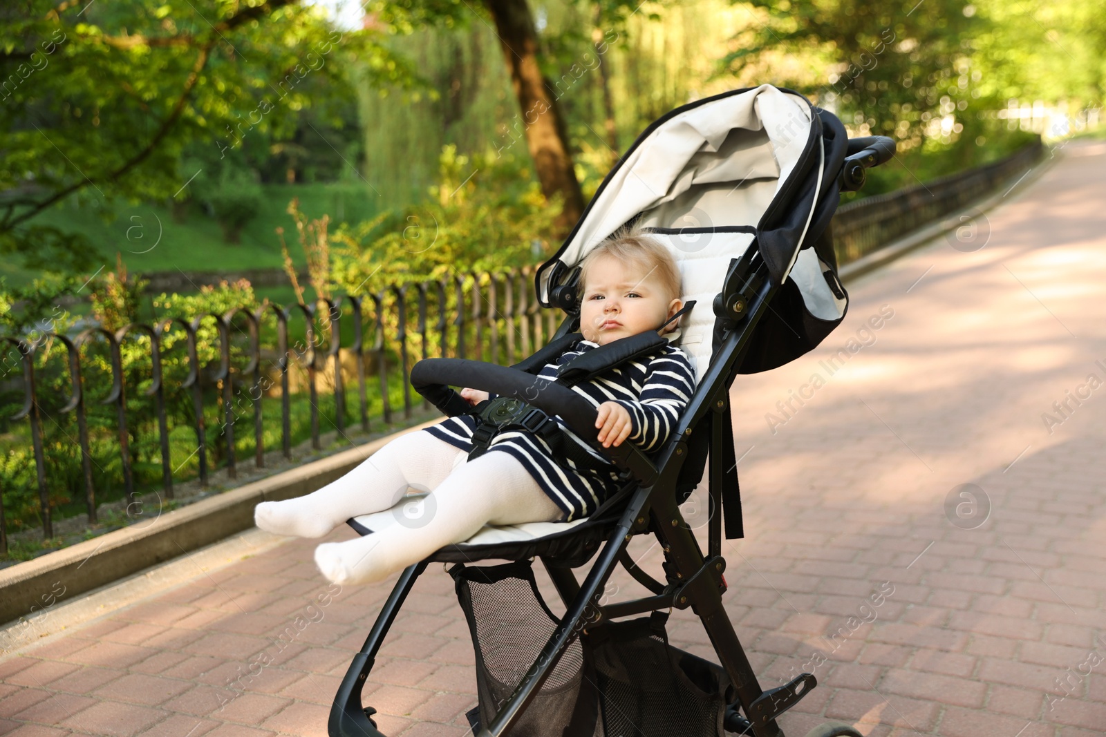 Cute little baby in stroller at park. Space for text Photo of Cute little baby in stroller at park. Space for text