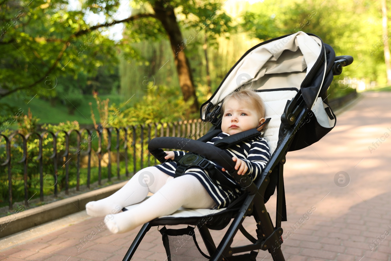 Cute little baby in stroller at park. Space for text Photo of Cute little baby in stroller at park. Space for text