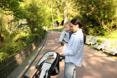 Photo of Mother with her cute baby in park
