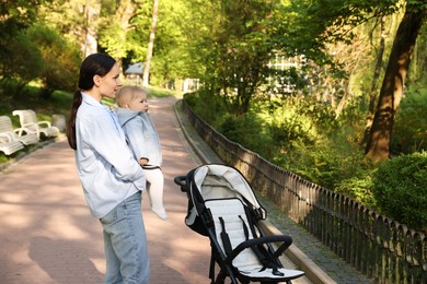 Photo of Mother with her cute baby in park