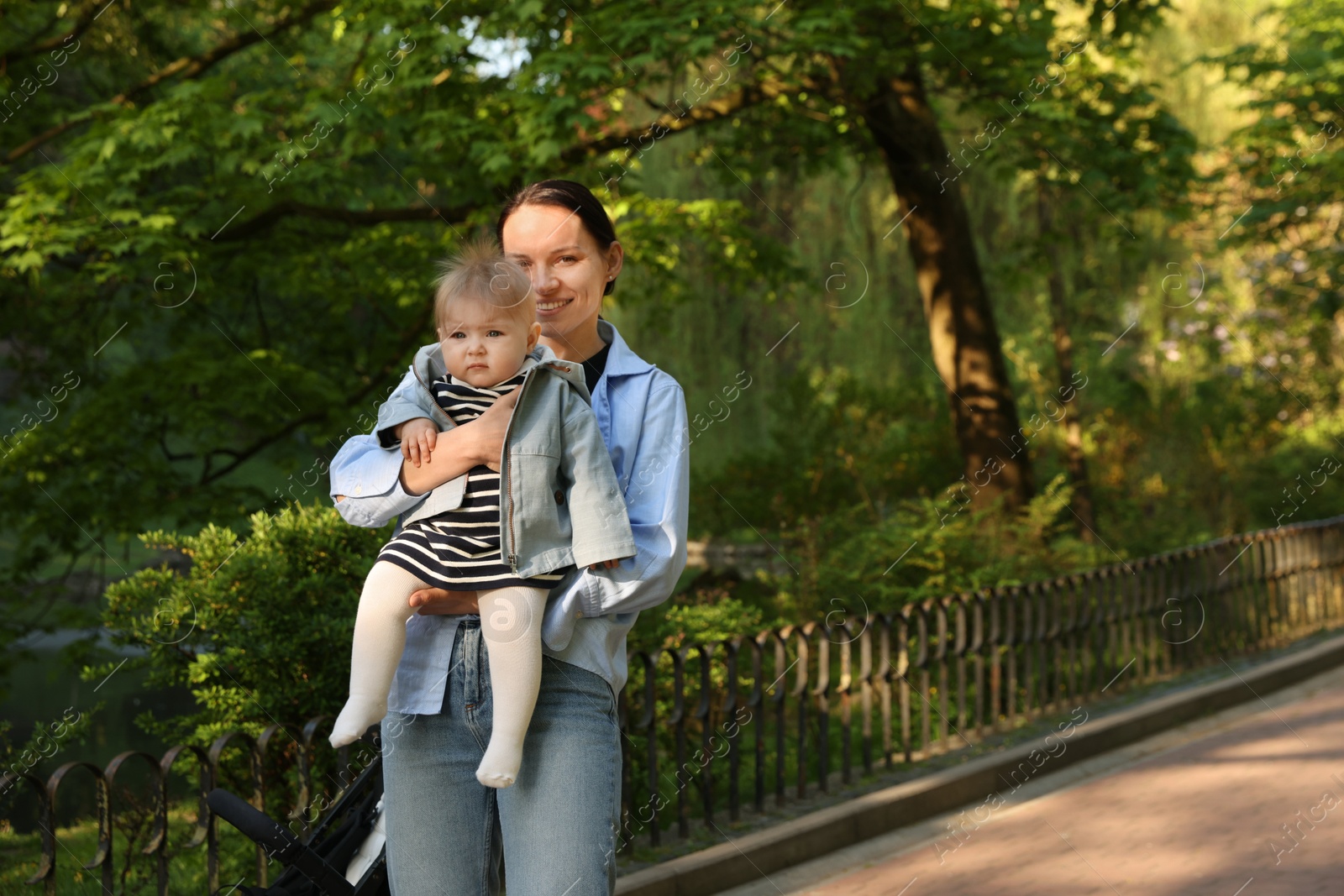 Photo of Mother with her cute baby in park