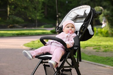 Photo of Cute little baby in stroller at park. Space for text