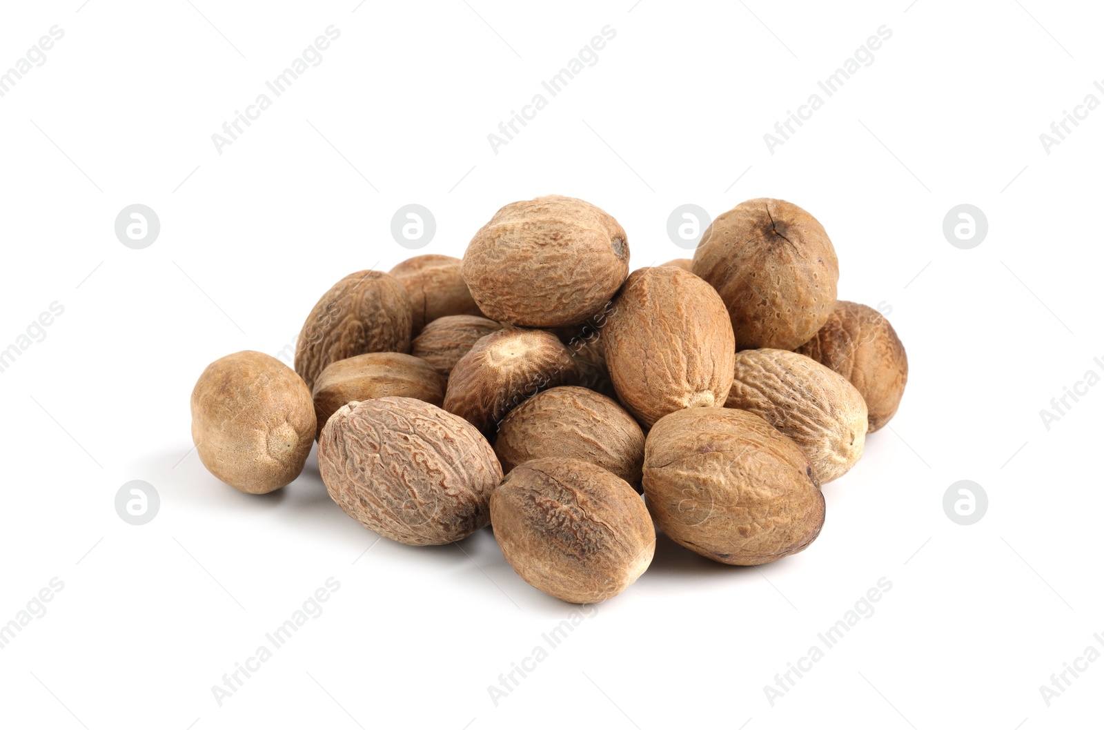 Pile of fresh nutmegs isolated on white Photo of Pile of fresh nutmegs isolated on white