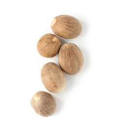 Photo of Fresh nutmegs isolated on white, top view