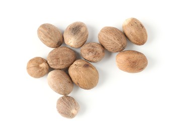 Photo of Fresh nutmegs isolated on white, top view